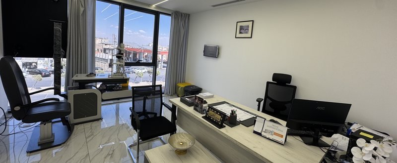 A consulting room with slit lamp and examination chair