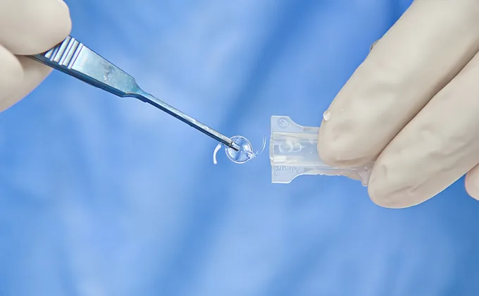An intraocular lens being loaded into its injector cartridge